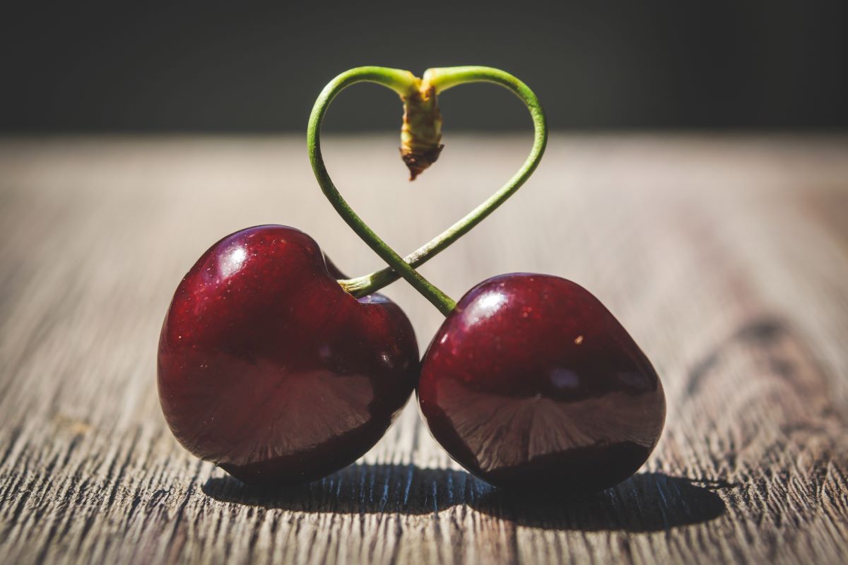 Two cherries intertwined together